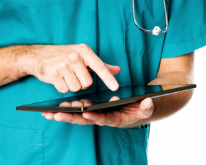 Doctor's hands using a tablet computer